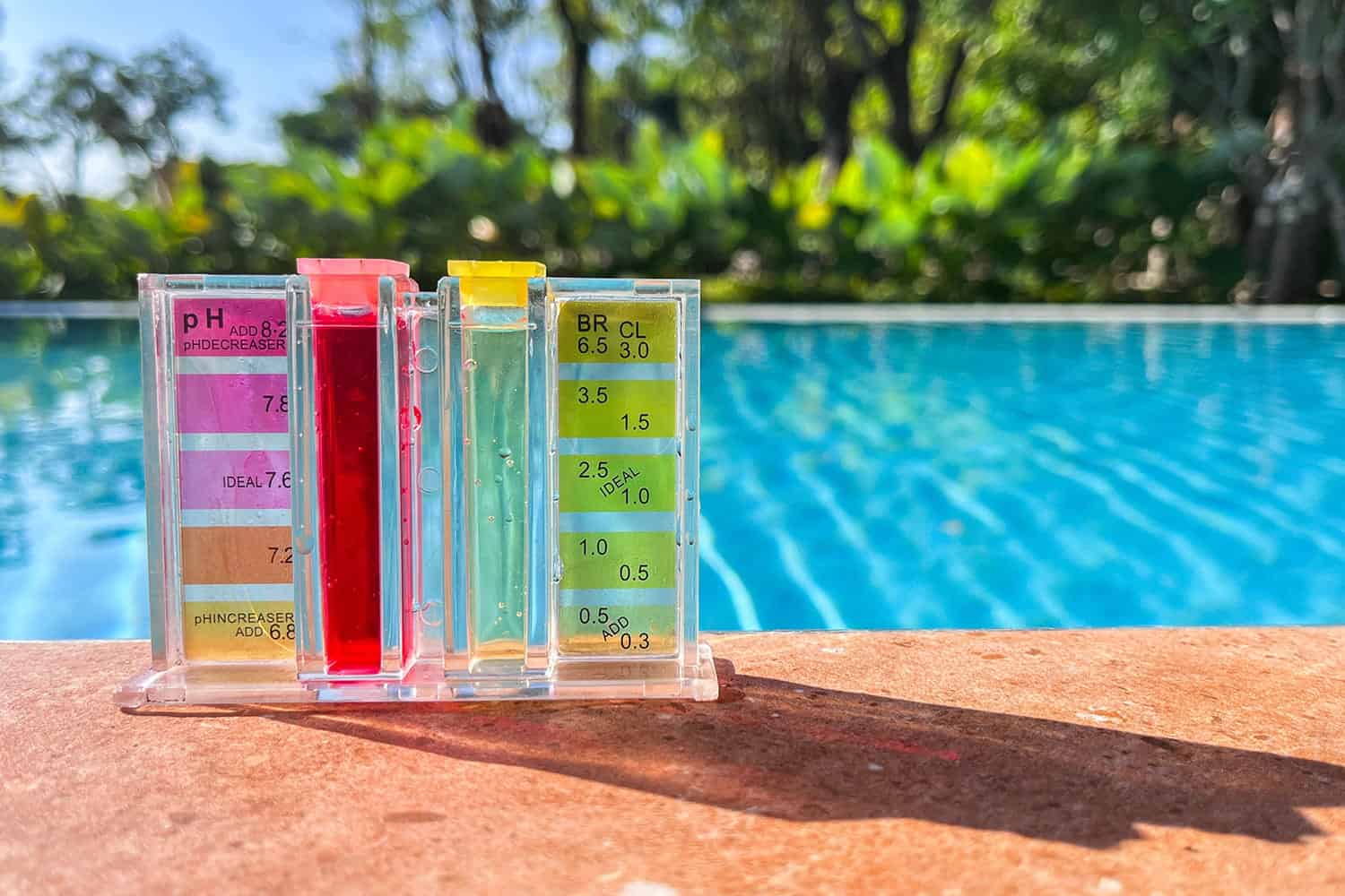 A pool with a water test kit sitting on the edge