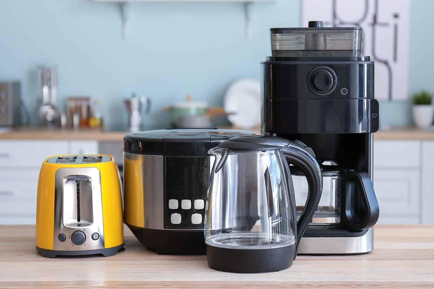 A kitchen with a coffee maker, toaster and blender