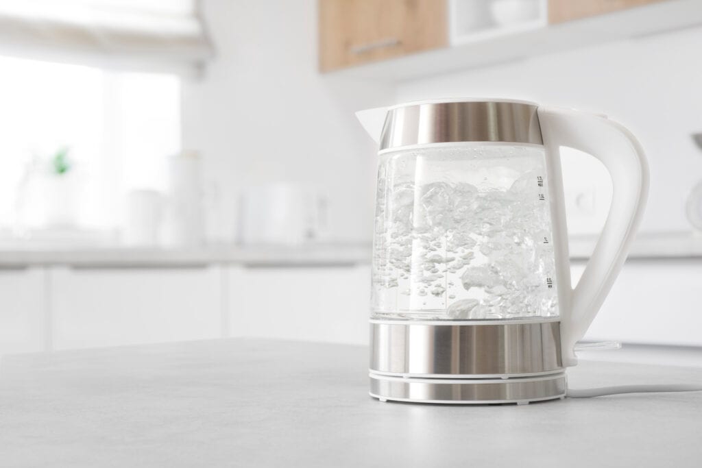 electric kettle filled with boiling water